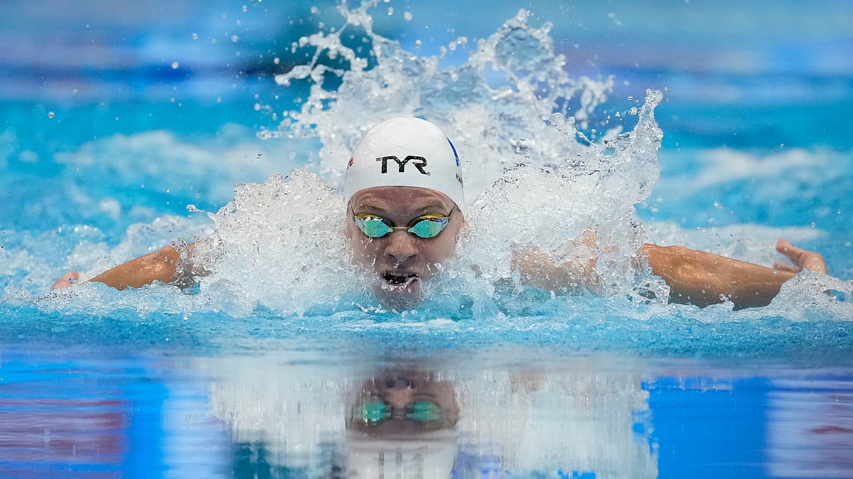 (AP Photo/Lee Jin-man, File) : FILE - Leon Marchand of France competes during the men's 200m individual medley final at the World Swimming Championships in Fukuoka, Japan, Thursday, July 27, 2023. Marchand has drawn comparisons to Michael Phelps, a link that was only strengthened by Phelps’ longtime coach, Bob Bowman, overseeing the 22-year-old’s rise to prominence. 